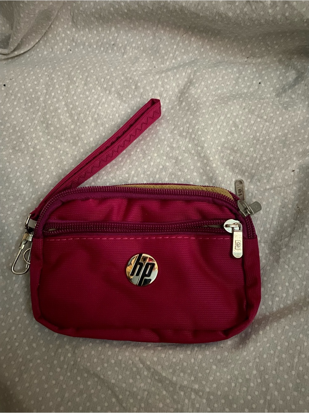 Pink nylon wristlet pouch branded with a prominent hp logo